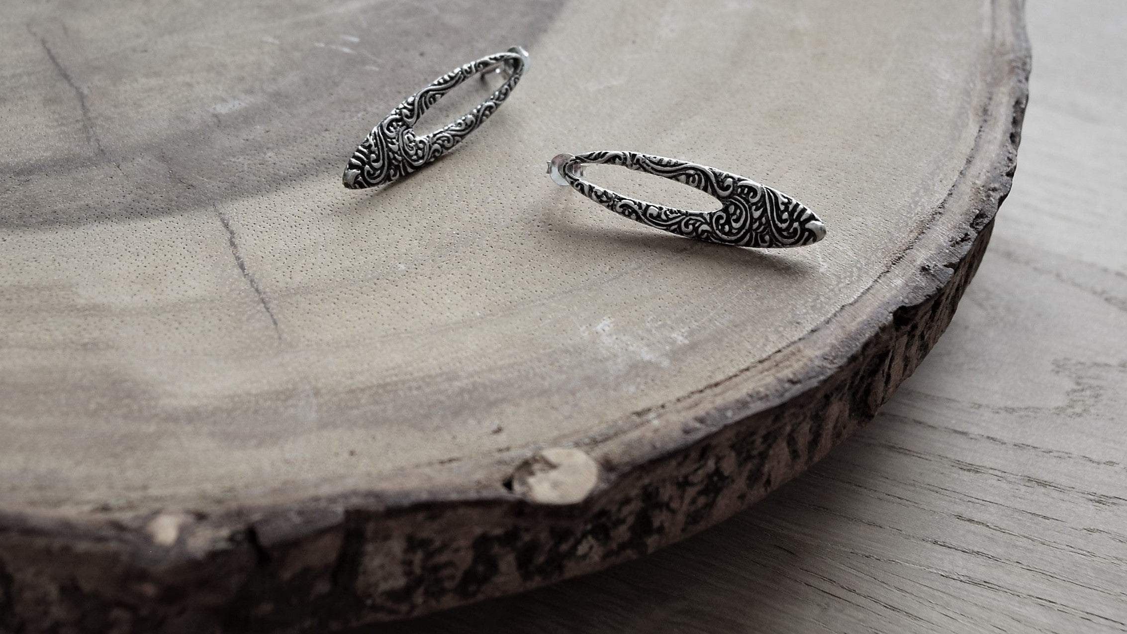 Shop online for gift for Chinese New Year and Valentine's Day: simple elegant oval shaped silver earrings with intricate patterns designed in Singapore, handmade in Bali.